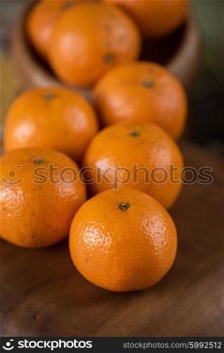 tangerines on wooden background. Ripe tangerines on wooden background