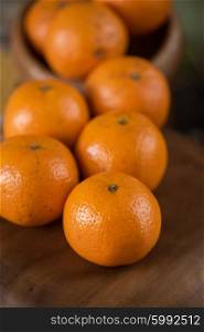 tangerines on wooden background. Ripe tangerines on wooden background