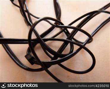 tangled black cable on a white background