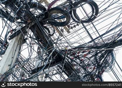 Tangled electrical wires on urban electric pole. Disorganized and messy to organization management concept. Closeup tangled electrical wires . Should take underground wire for beautiful landscape.