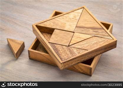 Tangram, a traditional Chinese Puzzle Game made of different wood parts to build abstract figures from them