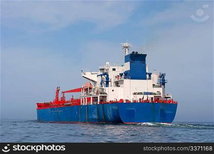 Tanker sailing in the sea with water splashes from engine