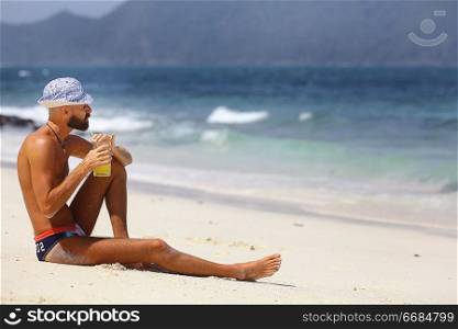 tanned, bearded man in sunglasses vacation concept