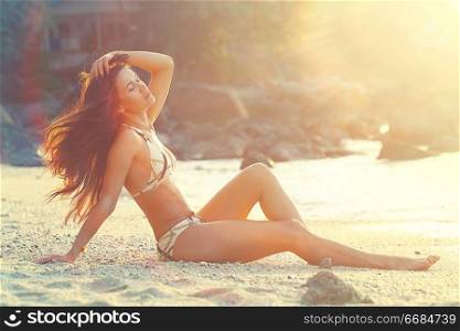 Tanned girl resting on the beach