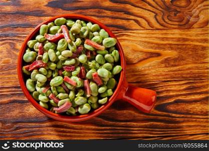 Tapas lima beans with iberico ham from Spain on wood