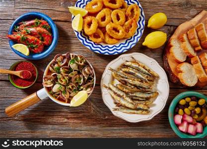 Tapas mix spanish clams olives shrimps calamari romana and fried anchovies fish