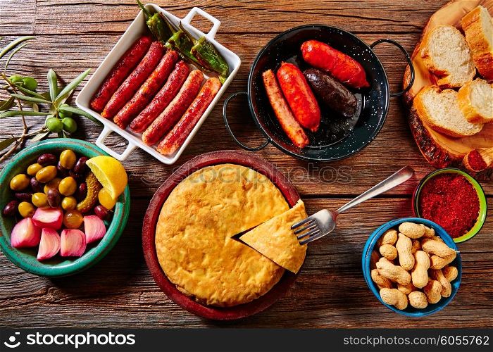 Tapas mix spanish potatoes omelette sausage olives bread and paprika