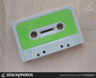 Tape cassette. Magnetic tape cassette for analog audio music recording on a wooden table