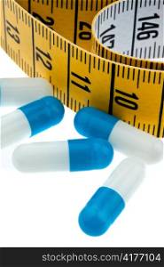 tape measure and tablets, as a symbol for diet pills