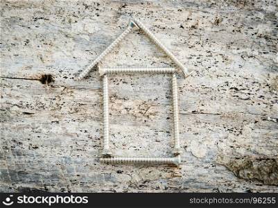 Tapping screws house on wood background, Dream house success concept