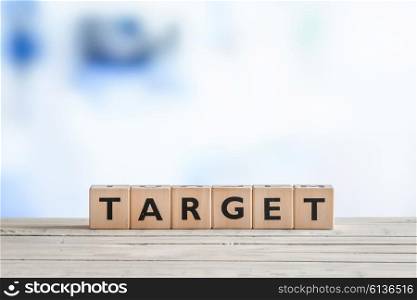 Target sign with wooden cubes on a table