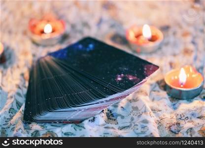 Tarot card with candlelight on the darkness background for Astrology Occult Magic illustration / Magic Spiritual Horoscopes and Palm reading fortune teller concept