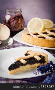 tart blackberry jam with a slice in a table spread