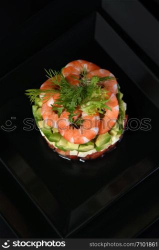 Tartare avocado with mozzarella, tomatoes and shrimps.
