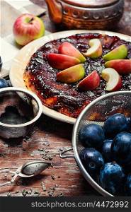 Tarte Tatin and plum. Apple pie with apples and plums in rustic style