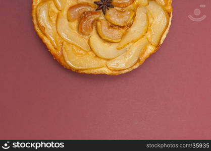 Tarte Tatin apple and pear tart pie isolated on claret background with copy space