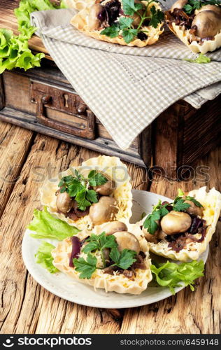 Tartlet with mushrooms. Tartlet - a small basket of fresh dough with mushroom snacks