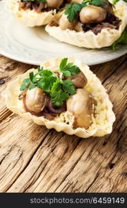 Tartlet with mushrooms. Tartlet - a small basket of fresh dough with mushroom snacks