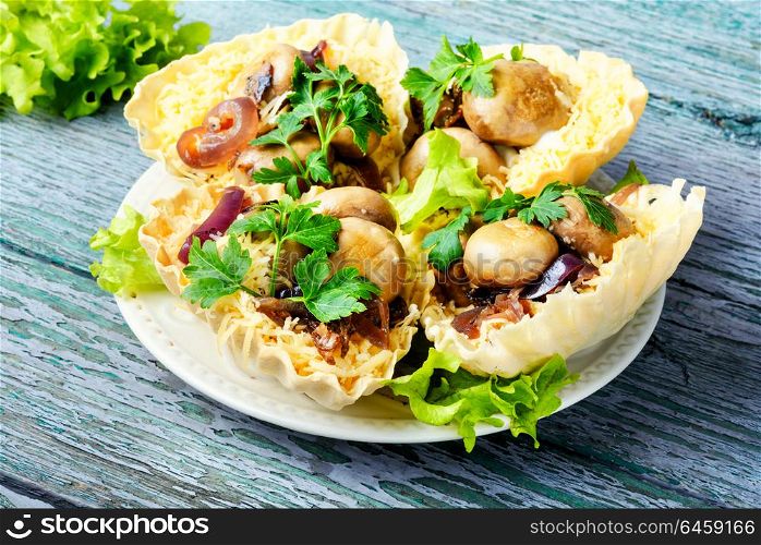 Tartlet with mushrooms. Tartlet - a small basket of fresh dough with mushroom snacks