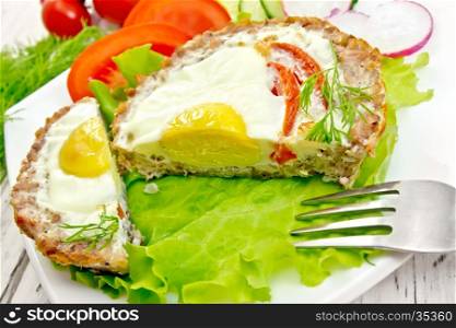 Tartlets meat with egg and tomato cut in the white plate on lettuce, bread and dill on the background wooden boards