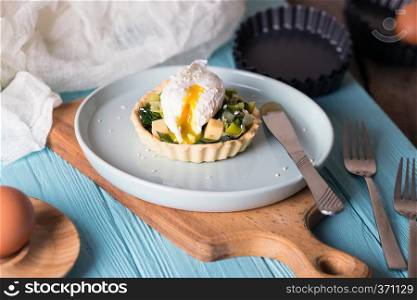 tartlets with leek and Perfect poached eggs  at the table 