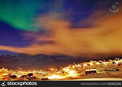 Tasiilaq in mist and northern lights in winter time
