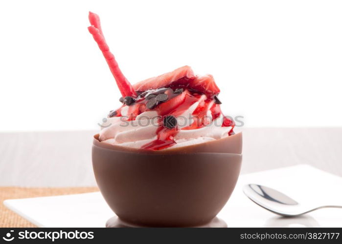 Tasteful strawberry and chocolate pastry mousse on black slate background.