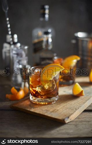 Tasty alcoholic old fashioned cocktail with orange slice