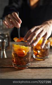 Tasty alcoholic old fashioned cocktail with orange slice