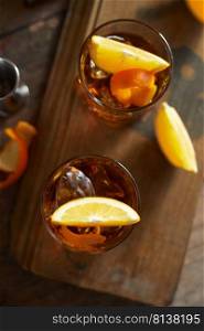 Tasty alcoholic old fashioned cocktail with orange slice 
