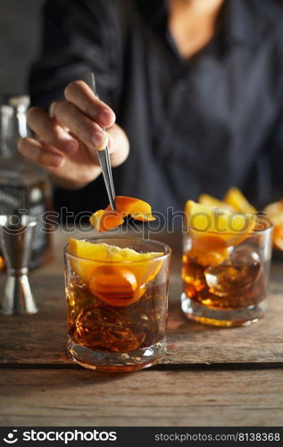 Tasty alcoholic old fashioned cocktail with orange slice 