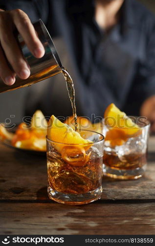 Tasty alcoholic old fashioned cocktail with orange slice 