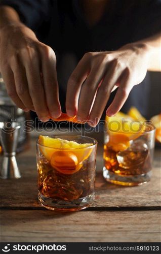 Tasty alcoholic old fashioned cocktail with orange slice 