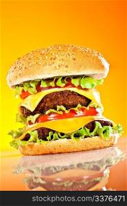 Tasty and appetizing hamburger on a yellow background
