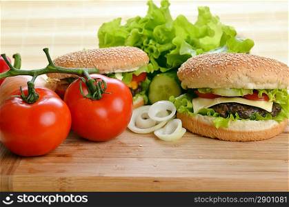 Tasty and appetizing hamburger on wooden plate