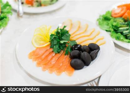 Tasty appetizer. Plate of red and white fish Salmon fillet