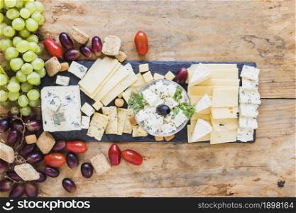 tasty appetizers with cheese plate tomatoes grapes. Resolution and high quality beautiful photo. tasty appetizers with cheese plate tomatoes grapes. High quality beautiful photo concept
