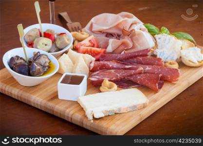 Tasty assortment of fresh italian food on a chopping board