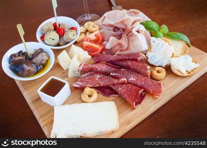 Tasty assortment of fresh italian food on a chopping board