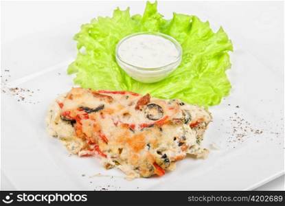 Tasty baked fish with vegetables dish isolated on a white background