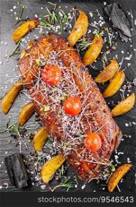 Tasty baked pork tenderloin in honey-orange glaze with potato wedges