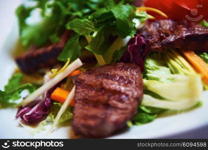 tasty bbq meat food, juicy beef steak with grilled cheese and salad in restaurant