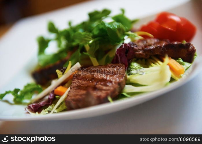 tasty bbq meat food, juicy beef steak with grilled cheese and salad in restaurant