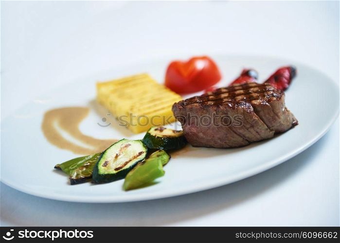 tasty bbq meat food, juicy beef steak with grilled cheese and salad in restaurant