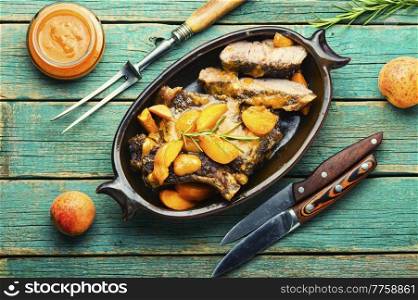 Tasty beef meat in apricot sauce.Veal steak in fruit marinade.. Veal steak fried with apricots