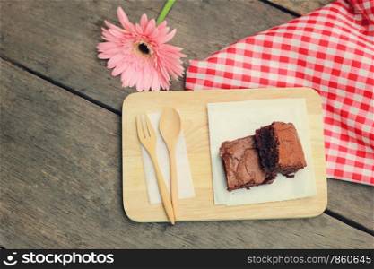 Tasty brownies with wooden spoon and fork, retro filter effect