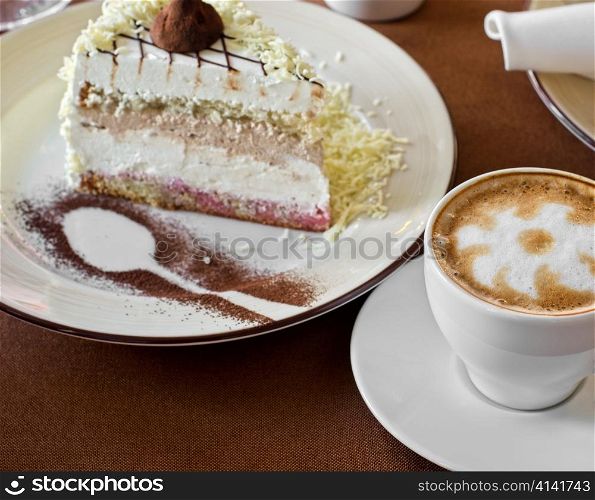 tasty cake at plate closeup with coffee cup