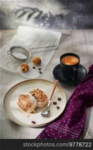 Tasty Cake Roll Filled With Walnuts And Coffee On Wooden Table