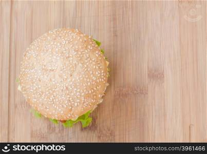 Tasty cheeseburger with lettuce, beef, double cheese and ketchup. From above view as background.