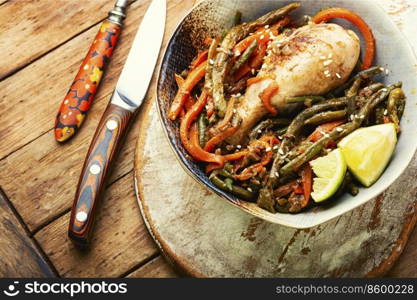 Tasty chicken legs stewed with asparagus beans and carrots.. Fried chicken legs and a vegetable side dish